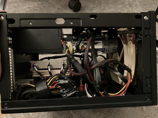 photo of the Network Storage PC from the side, showing the Noctua case fan and CPU cooler, data disks, PSU and cables
